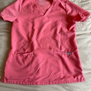 FIGS limited edition color Hot Coral Casma scrub top